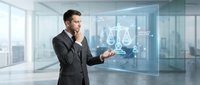 Professional businessman in dark suit interacting with holographic data visualization interface in modern glass office environment.