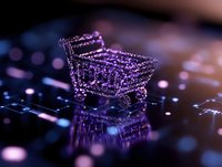 Glowing purple shopping cart wireframe hologram on computer keyboard with bokeh effect, digital commerce concept for online retail and e-commerce solutions.