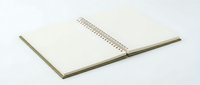 Open blank spiral notebook with clean white pages on neutral background for office supplies, education, writing, planning and note-taking projects.