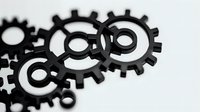 Interlocking black gears and cogs on white background, isolated mechanical elements for industrial design, technology, engineering, and business concepts.