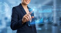 Professional businesswoman touching digital interface with financial data charts and analytics in modern office environment for technology presentations.