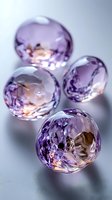 Four faceted amethyst gemstones with brilliant cuts displaying purple and lavender hues on reflective surface for luxury jewelry and precious stone concepts.