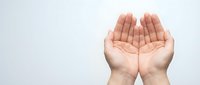 Open cupped hands gesture on white background showing palms in receiving or giving position for charity, prayer, offering concepts.