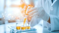 Laboratory scientist in protective gloves conducting research, pipetting yellow liquid into test tubes with glowing light effects and bokeh background.