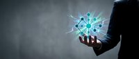 Businessman holding glowing digital network icon with interconnected nodes and light rays, representing technology, connectivity, and innovation for business solutions.
