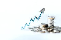 Stacked silver coins with rising blue arrow graph showing financial growth and investment success on white background, business concept for banking sector.