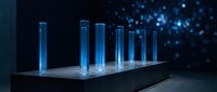 Laboratory test tubes with blue liquid glowing on modern platform against bokeh lights background for scientific research and medical analysis.