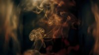 Swirling smoke wisps in warm golden and red tones rise against a dark background, creating a moody, atmospheric effect.
