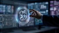 Businessman hand touching glowing shield icon with crisis response network text on digital interface background for cybersecurity and emergency management solutions.