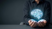 Professional businessman holding glowing digital brain hologram representing artificial intelligence, machine learning and innovative technology solutions.