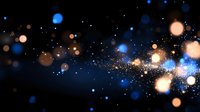 Magical blue and gold bokeh lights scattered on dark background with glowing particles and sparkles creating dreamy atmospheric effect.