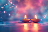 Two burning candles in clay oil lamps against dreamy blue and pink bokeh background, creating peaceful atmosphere for meditation or spiritual ceremony.