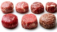 Raw beef steaks filet mignon cuts isolated on white background showing marbled texture and red meat quality for cooking and culinary preparation.