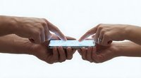 Two people touching a glowing smartphone screen together, symbolizing connection, sharing, and digital collaboration in modern technology.