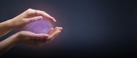 Hands holding glowing purple orb of light against dark background, representing energy, magic, innovation, and future technology concepts for design projects.