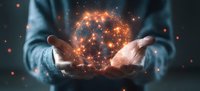 Glowing orange digital network sphere floating between hands against dark background, representing global connectivity and technological innovation.