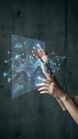 Hands interacting with futuristic holographic interface displaying data analytics, charts and network connections for business technology concepts.