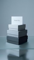 Stack of gray gradient gift boxes with a Thank You card on top, minimal elegant composition for retail, packaging, and gratitude concepts.