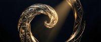 Elegant golden spiral with intricate ornamental patterns and warm lighting effects on dark background for luxury design projects.