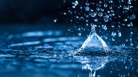 Water drop splash creating triangle shape formation with multiple droplets scattered around in dark blue background with ripple effect on water surface.