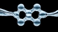 Molecular structure formed by water droplets and air bubbles creating abstract scientific pattern against black background, macro photography.