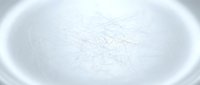 Empty white ceramic bowl with subtle scratches and wear marks showing kitchen use and age on clean background.