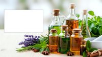 Natural essential oils in glass bottles with herbs spices and blank card for aromatherapy spa wellness and holistic medicine treatments.