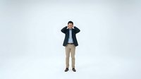 Young Asian businessman in dark suit covering ears with hands, standing isolated on white background for business stress and communication concepts.