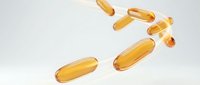 Golden vitamin capsules floating in air on white background isolated for health and wellness supplement design applications.