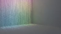 Abstract colorful gradient curtain with vertical lines creating rainbow spectrum effect on neutral background for modern interior design.
