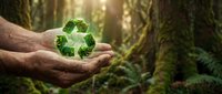 Hands holding green recycling symbol in forest environment, representing environmental conservation and sustainable practices.
