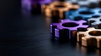 Metallic fidget spinners in purple, gold and blue colors arranged on dark surface with selective focus and dramatic lighting. Perfect for stress relief concept.