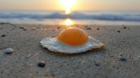 Sunny side up egg on sandy beach at sunrise with ocean waves and golden sun reflection creating surreal food photography composition on nature background.