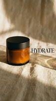 Amber glass jar with black lid containing hydrating skincare product, positioned on natural linen fabric with warm sunlight casting shadows, suitable for cosmetics and wellness marketing.