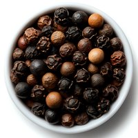 Black peppercorns in white ceramic bowl, mix of dried whole spices including tellicherry, malabar and white peppercorns on dark background.