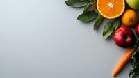 Fresh organic fruits and vegetables arranged in corner border on gray background with copy space for healthy eating and diet concept.