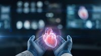 Medical professional hands holding glowing human heart hologram in modern hospital setting for cardiology healthcare technology concept.