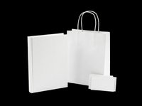 Blank white paper shopping bag with handles and matching gift box, isolated on transparent background, ready for branding, packaging mockups, print-on-demand products, and retail design projects.