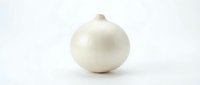 Whole white onion with papery skin isolated on white background, suitable for food photography, cooking, and culinary design projects.