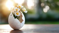 Fresh white daisies arranged in cracked eggshell vase on wooden surface with soft bokeh background and warm sunlight creating spring atmosphere.