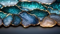 Luxurious agate slices with gold edges displaying vibrant teal, blue and amber colors in elegant mineral specimen arrangement for jewelry design.