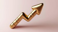 Golden arrow chart showing upward trend on soft pink background, symbolizing financial growth, success, and positive business performance.
