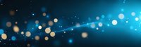 Glowing blue and gold bokeh lights on dark background with dynamic light trail effect creating magical atmospheric abstract panoramic composition.