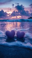 Two purple glittery hearts on wet sand at romantic beach sunset with sparkling lights and dramatic clouds reflecting in ocean waves for love concepts.