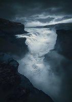 Dramatic waterfall cascading through dark rocky canyon under moody stormy sky with turbulent waters creating misty atmosphere in rugged wilderness landscape.