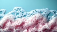 Colorful soap foam texture with pink and blue gradient colors creating abstract wavy pattern with bubbles and soft dreamy effect. Great for backgrounds.