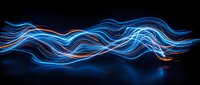 Glowing neon light waves flowing across dark background, creating dynamic blue and orange streaks for modern design, technology, and motion graphics projects.