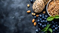 Fresh blueberries, almonds, chickpeas and whole grain bread on dark stone background with copy space. Healthy vegetarian protein sources and superfoods.