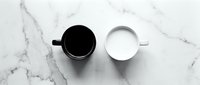 Two ceramic mugs on marble surface, one filled with black coffee and one with white milk, overhead flat lay composition for beverage, lifestyle and kitchen concepts.