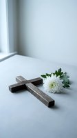 Wooden cross with white chrysanthemum flower on clean surface near window for memorial, funeral, religious ceremony, grief support and spiritual comfort.